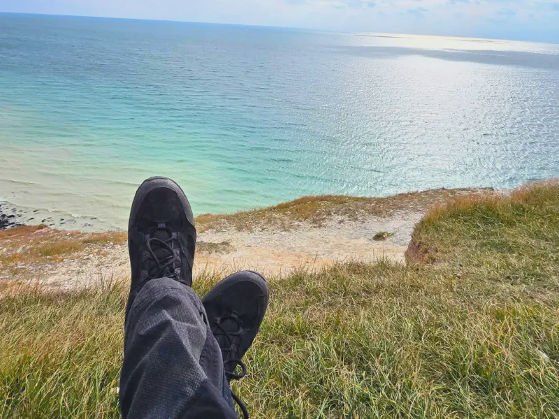Our hiking boots on the cliff above the turquoise sea