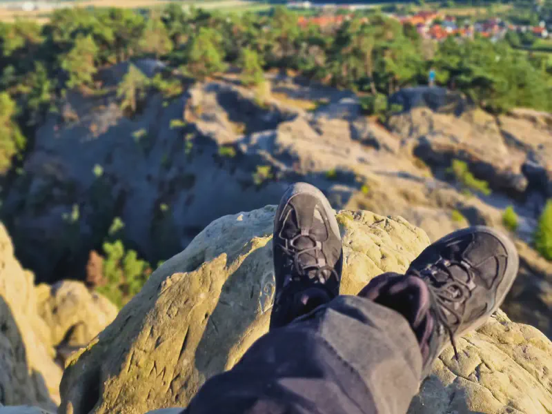 Hiking boots on a rocky ledge in the evening light