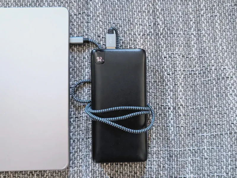 Power bank charging a laptop.