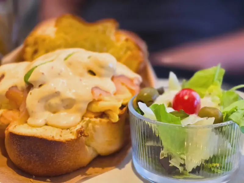 Egg drop sandwich with creamy sauce and side salad