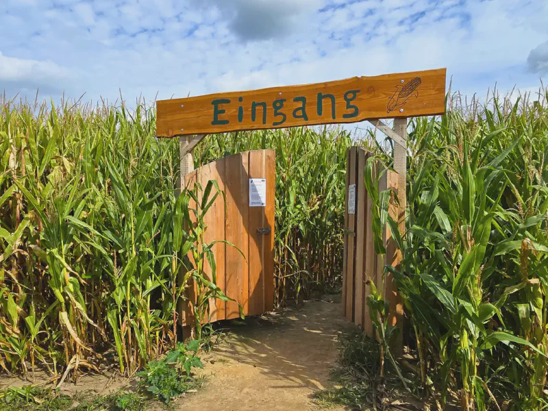 Wooden entrance to the corn maze at Hof Bartels