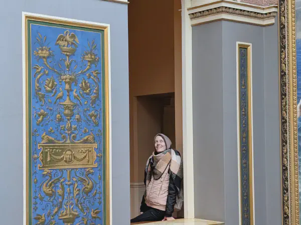 Gina looking up in the staircase